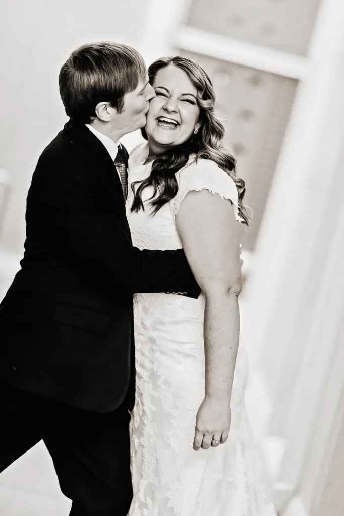 happy bride kissed by her groom