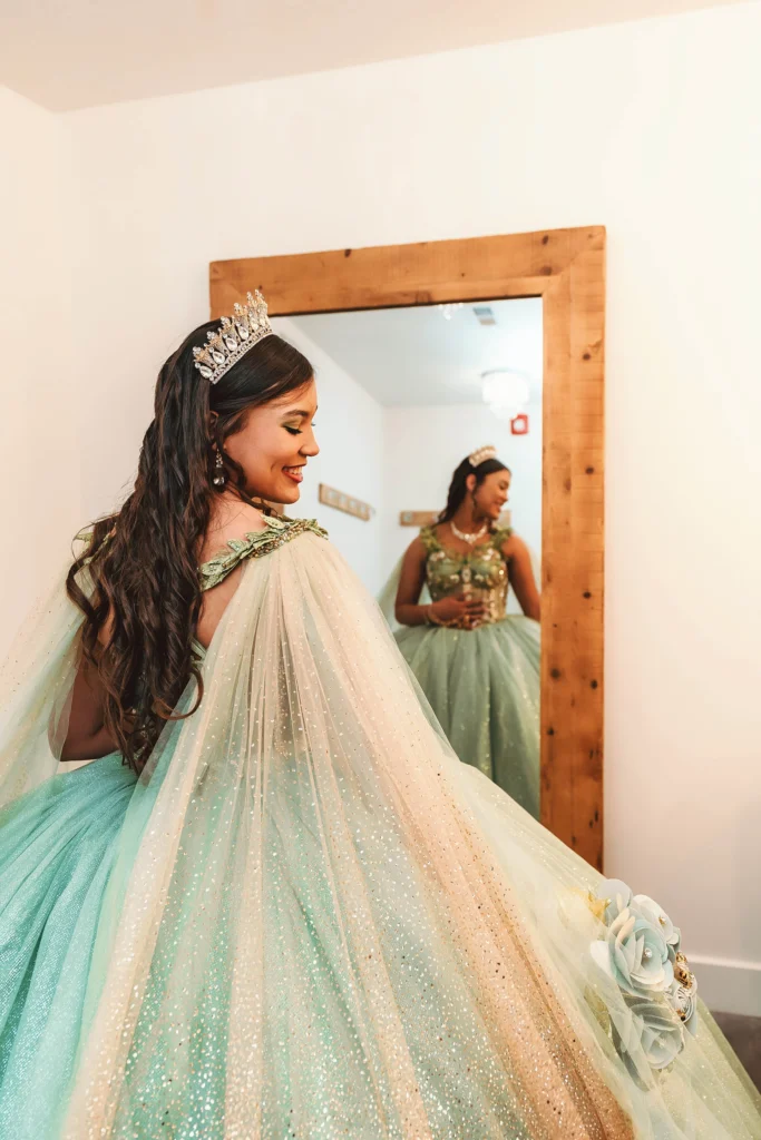 Quinceañera posing in a front of mirror